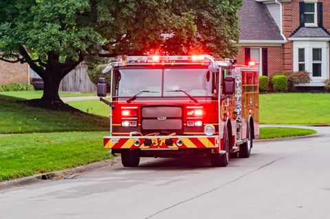 Fire engine with emergency lights in residential neighborhood