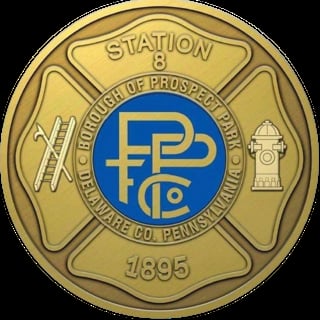 Brass badge for Fire Station 8 of Prospect Park Fire Company, Delaware County Pennsylvania, established 1895, featuring ladder and fire hydrant symbols